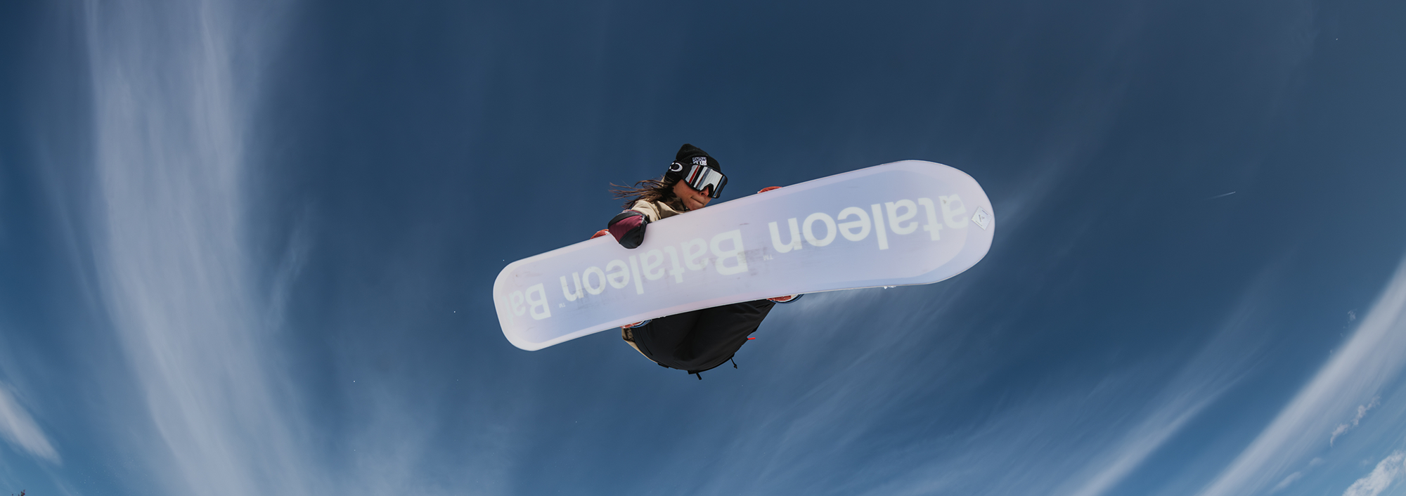 snowboarder jumping in the air displaying the bataleon women's snowboard collection