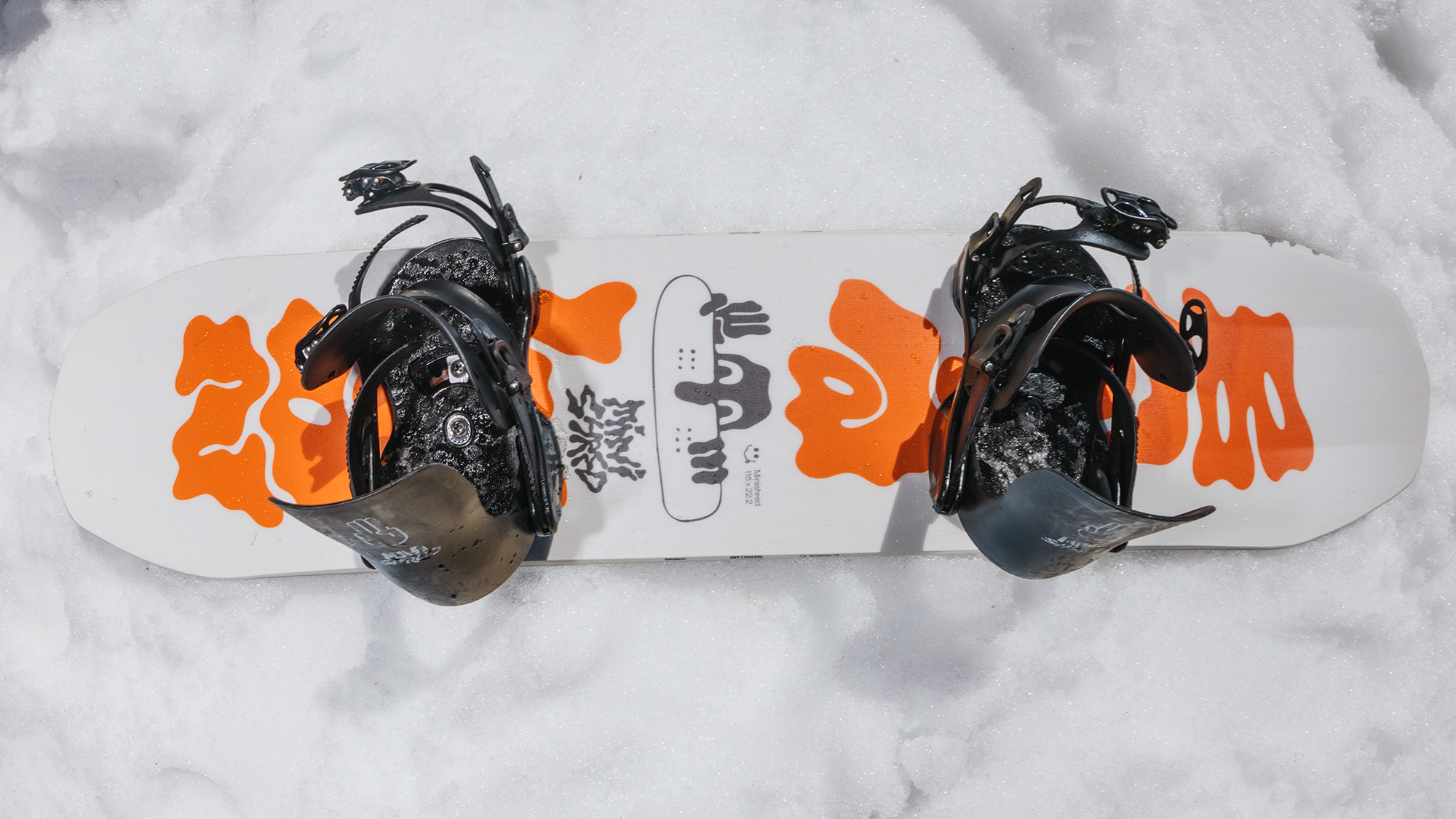 kids snowboard bindings laying in the snow